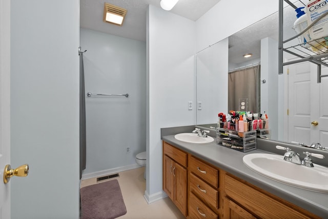 bathroom with visible vents, a sink, and toilet