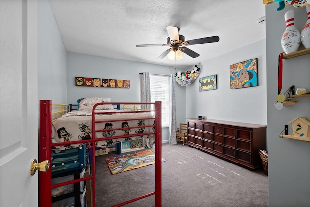 bedroom featuring a ceiling fan, a textured ceiling, and carpet