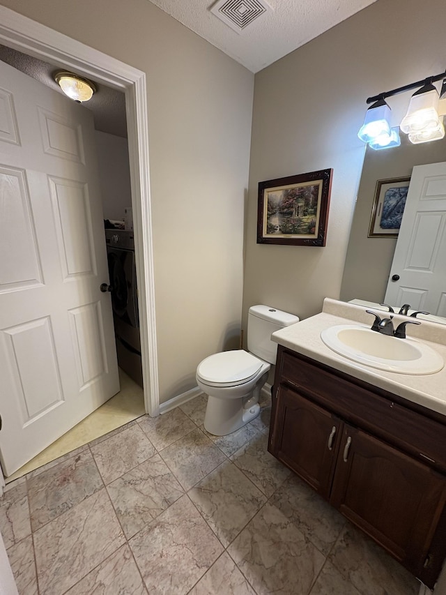 2413 Tana Way, Clarksville, TN 37042 - bathroom with visible vents, toilet, vanity, a textured ceiling, and washer / clothes dryer