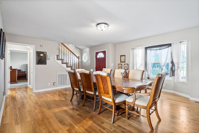 2413 Tana Way, Clarksville, TN 37042 - dining room with baseboards, stairs, visible vents, and light wood-style flooring