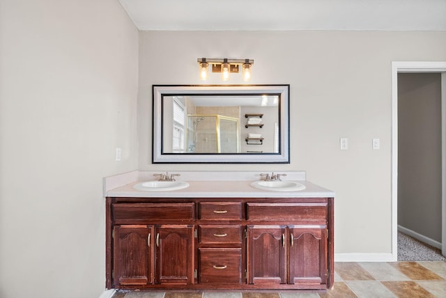 2413 Tana Way, Clarksville, TN 37042 - bathroom featuring baseboards, a sink, double vanity, and a stall shower