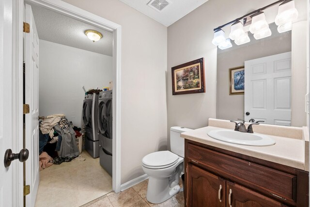2413 Tana Way, Clarksville, TN 37042 - bathroom featuring washing machine and dryer, visible vents, vanity, and toilet