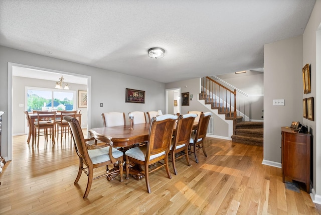2413 Tana Way, Clarksville, TN 37042 - dining area featuring light wood-style floors, stairway, and a textured ceiling