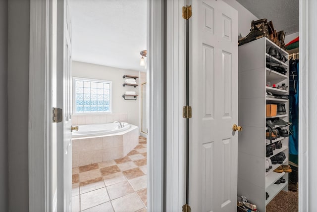2413 Tana Way, Clarksville, TN 37042 - bathroom with a bath, tile patterned floors, and a spacious closet