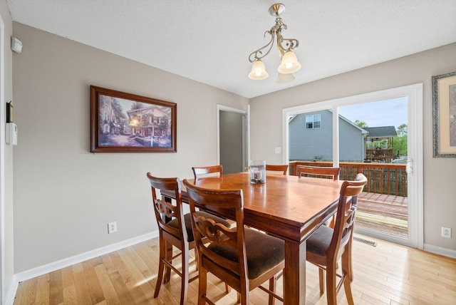 2413 Tana Way, Clarksville, TN 37042 - dining room with light wood finished floors, baseboards, and an inviting chandelier