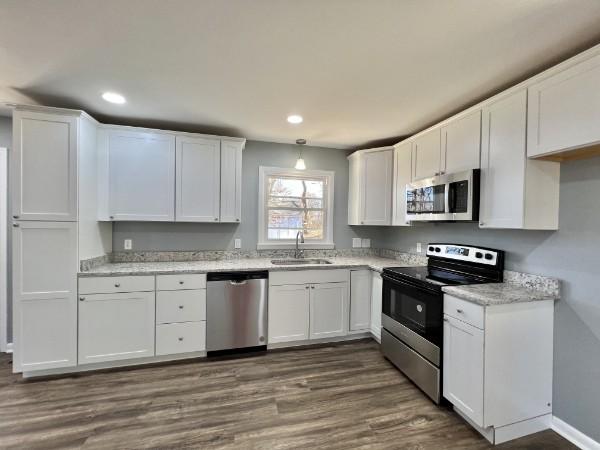 210 Ragan St, Tullahoma, TN 37388 - kitchen with white cabinets, recessed lighting, stainless steel appliances, and a sink