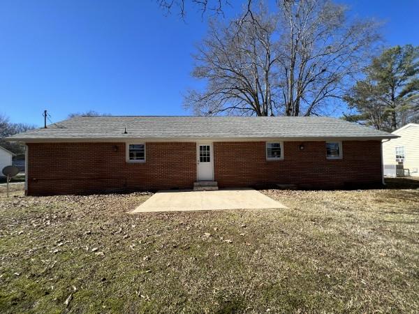 210 Ragan St, Tullahoma, TN 37388 - rear view of property featuring brick siding and a patio