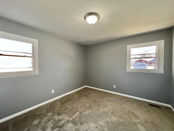 210 Ragan St, Tullahoma, TN 37388 - empty room featuring baseboards, visible vents, and carpet