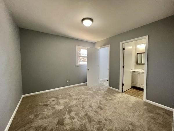 210 Ragan St, Tullahoma, TN 37388 - unfurnished bedroom featuring carpet, baseboards, and connected bathroom