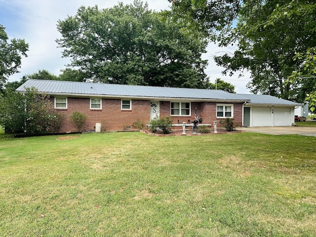 946 Monument Rd, Summertown, TN 38483 - ranch-style house featuring an attached garage, metal roof, a front yard, and concrete driveway