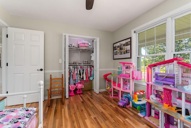 game room with baseboards and wood finished floors