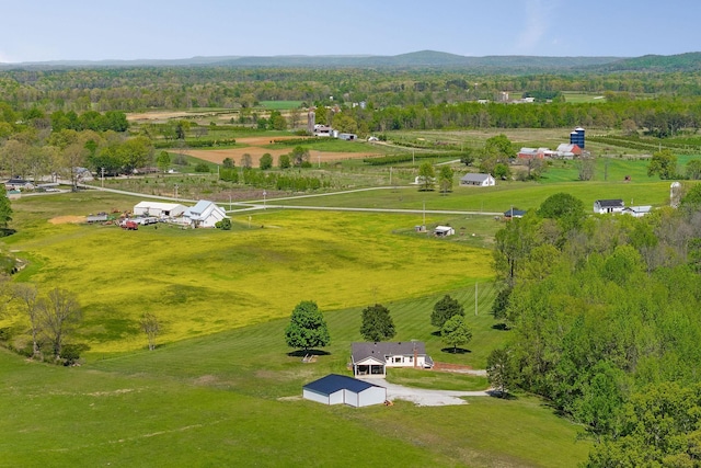 birds eye view of property with a rural view and a wooded view