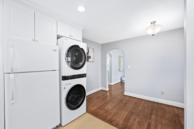 120 39th Ave N, Nashville, TN 37209 - laundry room featuring stacked washer and dryer, arched walkways, baseboards, wood finished floors, and laundry area