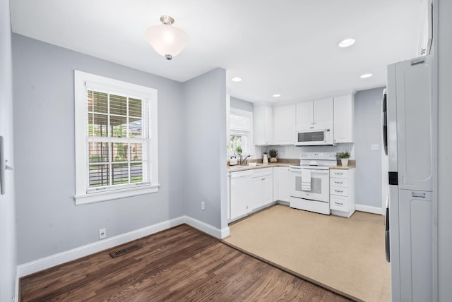 120 39th Ave N, Nashville, TN 37209 - kitchen with visible vents, baseboards, white appliances, and white cabinetry