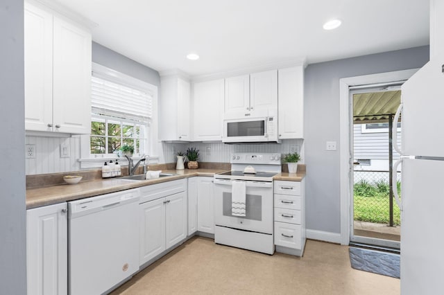 120 39th Ave N, Nashville, TN 37209 - kitchen featuring white cabinets, a sink, and white appliances