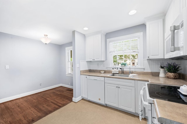 120 39th Ave N, Nashville, TN 37209 - kitchen featuring a sink, white appliances, light wood-type flooring, baseboards, and white cabinetry
