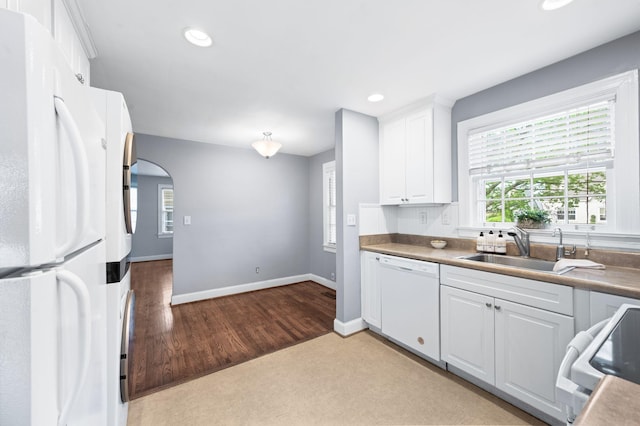 120 39th Ave N, Nashville, TN 37209 - kitchen with a sink, white appliances, arched walkways, white cabinets, and recessed lighting