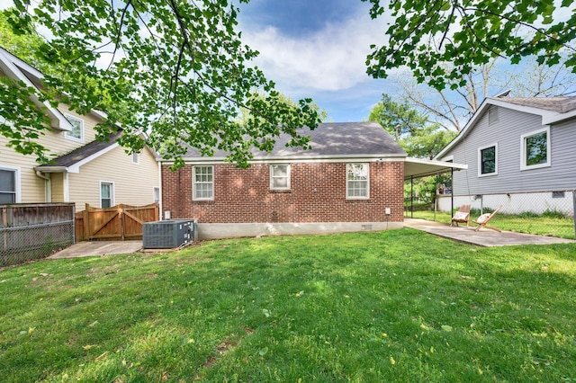 120 39th Ave N, Nashville, TN 37209 - back of house featuring central AC unit, a gate, brick siding, a patio area, and a lawn