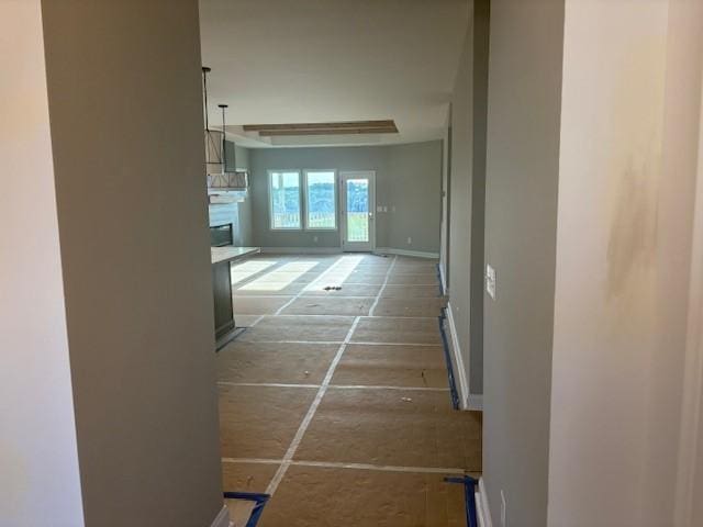 hallway featuring baseboards