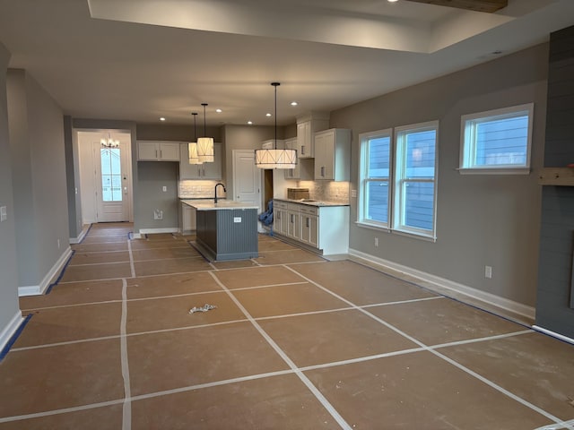 kitchen featuring tasteful backsplash, white cabinetry, baseboards, and recessed lighting
