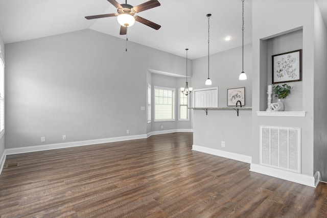 159 Matheson Dr, Clarksville, TN 37043 - unfurnished living room featuring high vaulted ceiling, dark wood-type flooring, visible vents, and ceiling fan with notable chandelier