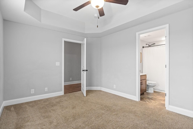 159 Matheson Dr, Clarksville, TN 37043 - unfurnished bedroom with a tray ceiling, carpet floors, ensuite bath, and baseboards