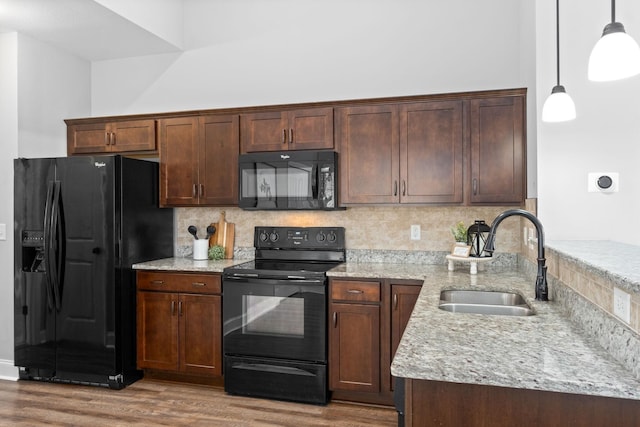 159 Matheson Dr, Clarksville, TN 37043 - kitchen featuring light stone countertops, wood finished floors, a sink, and black appliances
