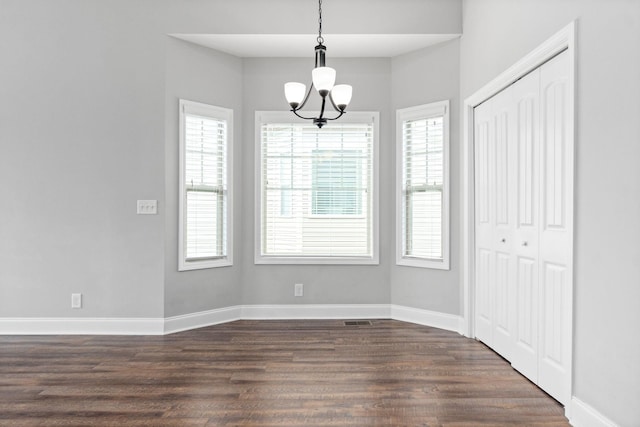 159 Matheson Dr, Clarksville, TN 37043 - unfurnished dining area featuring a chandelier, plenty of natural light, baseboards, and dark wood-style floors