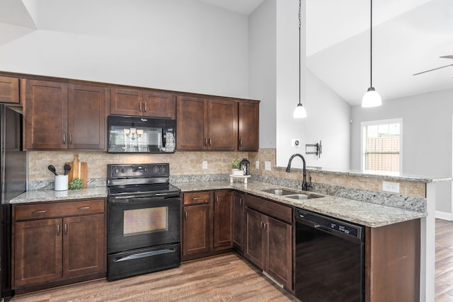 159 Matheson Dr, Clarksville, TN 37043 - kitchen with a sink, black appliances, light wood-style flooring, backsplash, and a peninsula