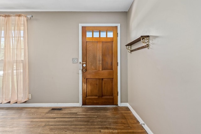 entrance foyer with dark wood-type flooring, visible vents, and baseboards
