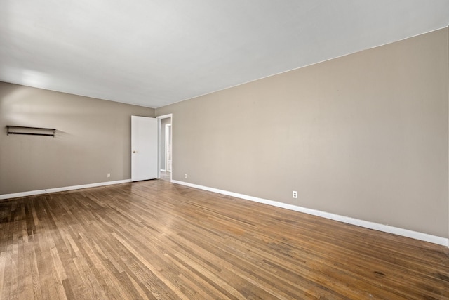 empty room with wood finished floors and baseboards