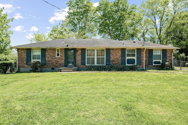 ranch-style house with fence, a front lawn, and brick siding