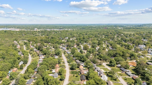 birds eye view of property with a view of trees