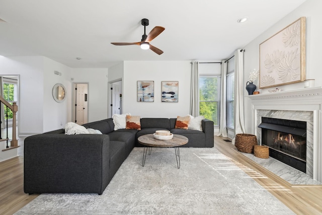 living room featuring ceiling fan, a healthy amount of sunlight, and wood finished floors