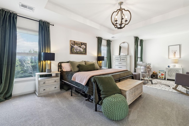 bedroom with visible vents, carpet floors, and multiple windows