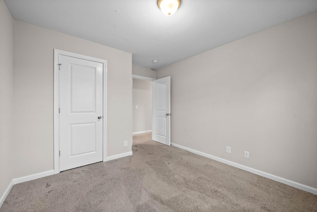 unfurnished bedroom featuring baseboards and carpet flooring