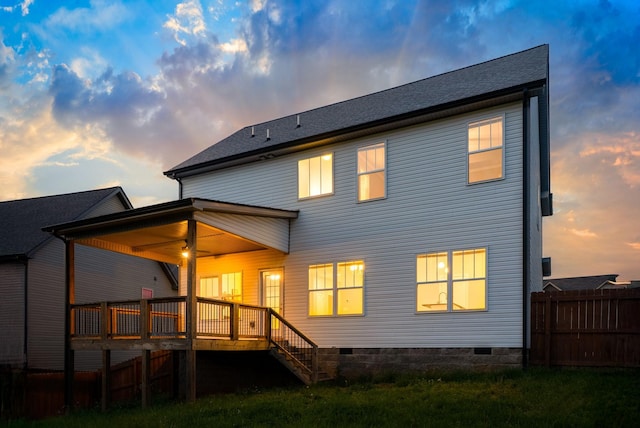 back of property with fence, stairway, and a deck