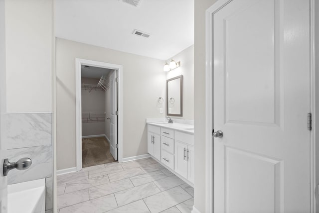 bathroom with a sink, double vanity, visible vents, baseboards, and marble finish floor