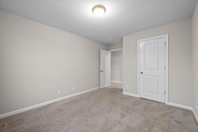 unfurnished bedroom with carpet flooring and baseboards