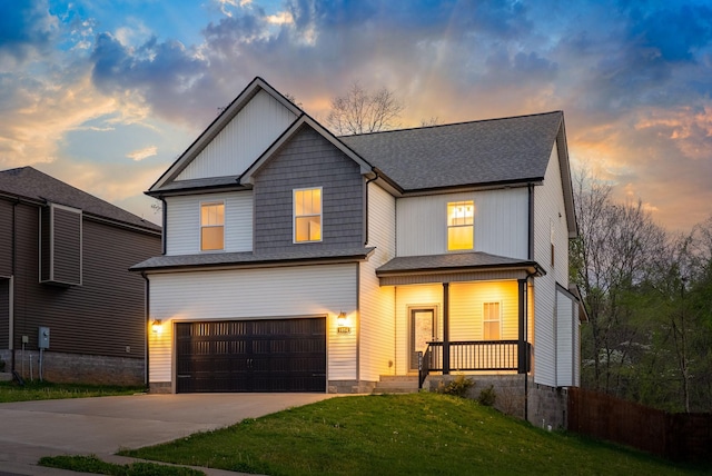 traditional home with a lawn, driveway, a shingled roof, covered porch, and a garage