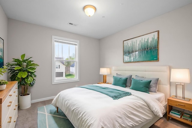 carpeted bedroom featuring visible vents and baseboards