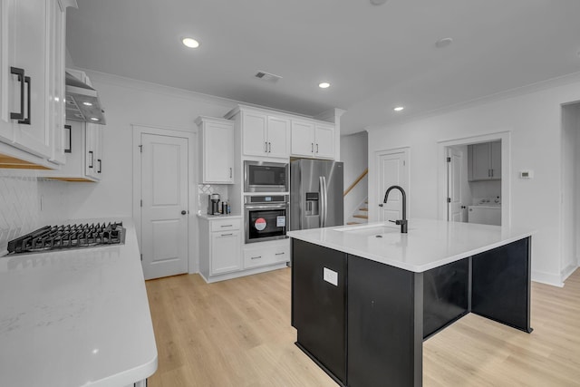 698 Conifer Dr, Spring Hill, TN 37174 - kitchen with appliances with stainless steel finishes, a sink, washer / clothes dryer, ornamental molding, and white cabinetry