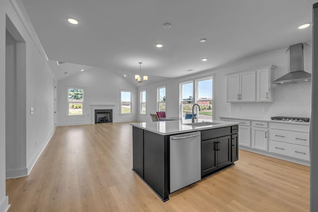 698 Conifer Dr, Spring Hill, TN 37174 - kitchen with stainless steel appliances, wall chimney range hood, a sink, healthy amount of natural light, and recessed lighting