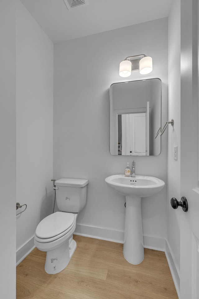 698 Conifer Dr, Spring Hill, TN 37174 - half bathroom with toilet, wood finished floors, baseboards, and a sink
