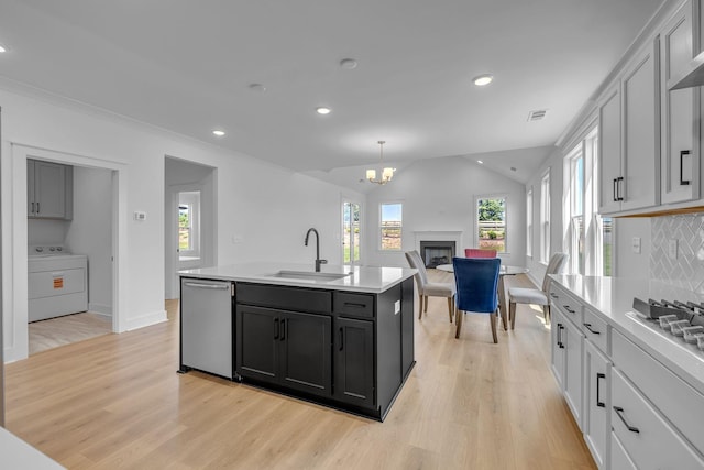 698 Conifer Dr, Spring Hill, TN 37174 - kitchen with washer / clothes dryer, a sink, dishwasher, light wood-style flooring, and recessed lighting