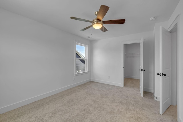 698 Conifer Dr, Spring Hill, TN 37174 - unfurnished bedroom with light colored carpet, baseboards, a spacious closet, a ceiling fan, and a closet