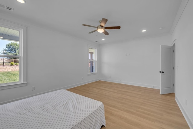 698 Conifer Dr, Spring Hill, TN 37174 - unfurnished bedroom with multiple windows, light wood-style floors, baseboards, crown molding, and recessed lighting