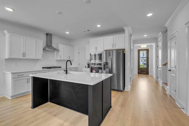 698 Conifer Dr, Spring Hill, TN 37174 - kitchen featuring wall chimney exhaust hood, appliances with stainless steel finishes, a sink, light countertops, and light wood-style floors