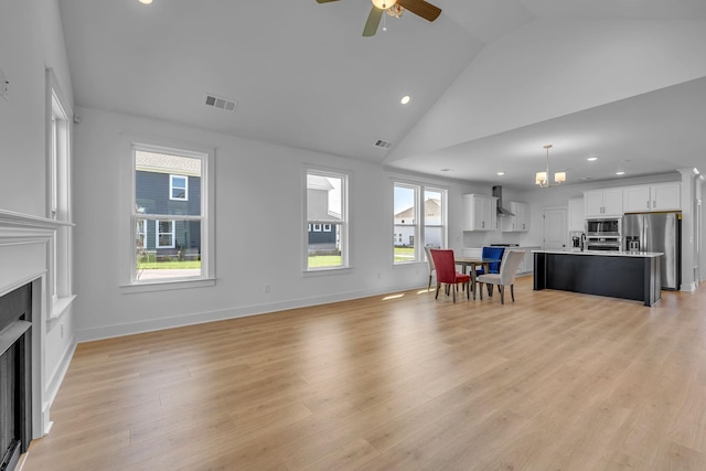 698 Conifer Dr, Spring Hill, TN 37174 - living room featuring a fireplace, a ceiling fan, recessed lighting, light wood-style floors, and high vaulted ceiling