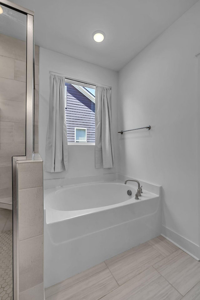 698 Conifer Dr, Spring Hill, TN 37174 - bathroom featuring a garden tub and tiled shower